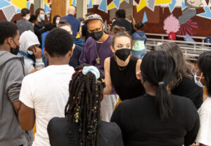 Two dancers talk to a group of students