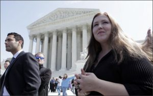 Savana Redding, right, and her lawyer Adam Wolf, stand outside the Supreme Court in Washington, Tuesday, April 21, 2009, after the court heard the case of Redding who was strip searched when she was 13 years old by school officials looking for prescription-strength ibuprofen pills . (AP Photo/Evan Vucci)