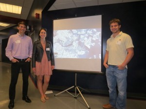 Dan, Maddie and Cole standing with their group project regarding rising sea level and its direct impacts on major US cities. (Not pictured: group members, Ryan and Griffin)