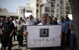 George, 35, protests with other commercial drivers with the app-based, ride-sharing company Uber against working conditions outside the company's office in Santa Monica, California June 24, 2014. REUTERS/Lucy Nicholson (UNITED STATES - Tags: BUSINESS EMPLOYMENT TRANSPORT CIVIL UNREST) - RTR3VKJ9